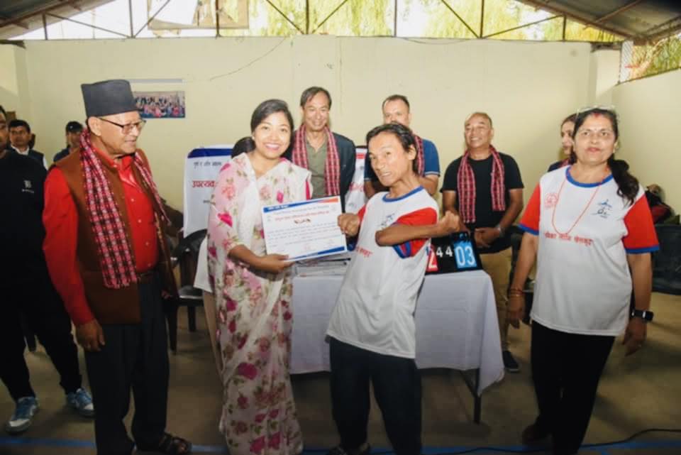 a boccia player buddha rai receiving award from Deputy Mayor